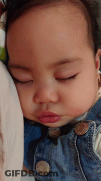 A Baby Wearing A Denim Jacket With The Letter O On The Buttons GIF