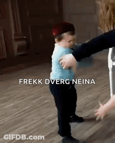A Baby Wearing A Hat Is Being Held By A Person . GIF