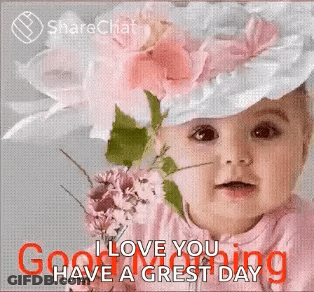 A Baby Wearing A Hat With Flowers On It And A Bouquet Of Flowers . GIF