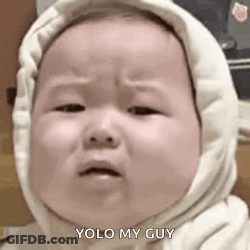 A Baby Wearing A Hooded Sweatshirt Is Crying And Making A Face . GIF
