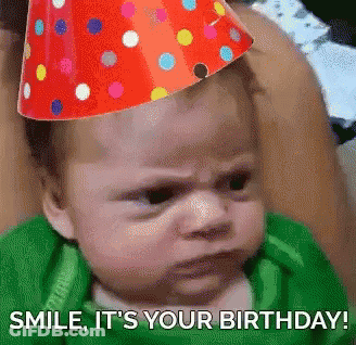 A Baby Wearing A Party Hat With The Words Smile It 'S Your Birthday Written Below It GIF