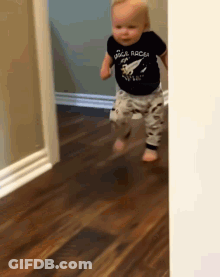 A Baby Wearing A Shirt That Says Space Racer GIF