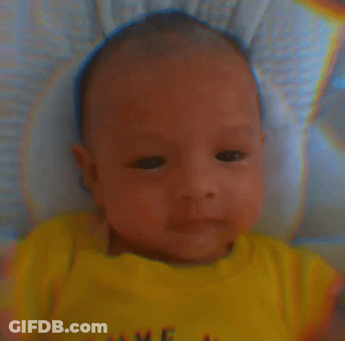 A Baby Wearing A Yellow Shirt That Says Love GIF