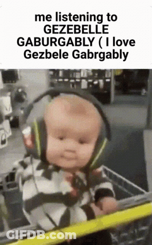 A Baby Wearing Headphones Is Sitting In A Shopping Cart .. GIF