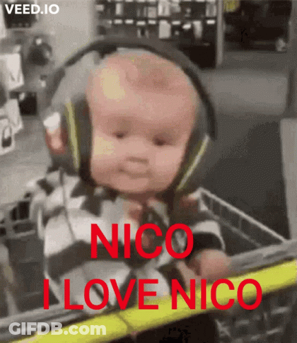 A Baby Wearing Headphones Is Sitting In A Shopping Cart With The Words " Nico I Love Nico " On It GIF