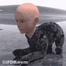 A Baby With A Bald Head Is Crawling On The Floor . GIF