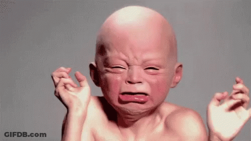 A Baby With A Bald Head Is Crying With His Eyes Closed . GIF