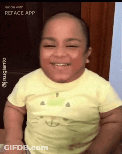 A Baby With A Cat On His Shirt Is Smiling GIF