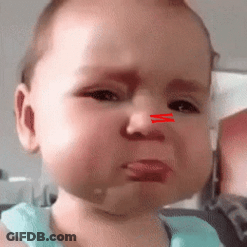 A Baby With A Red Line On His Nose Is Crying . GIF