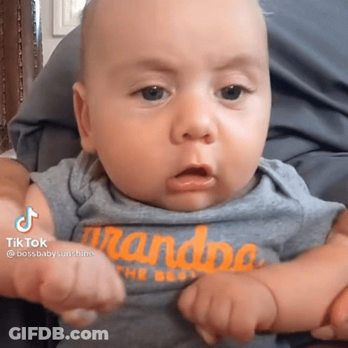 A Baby With A Shirt That Says Grandpa On It GIF