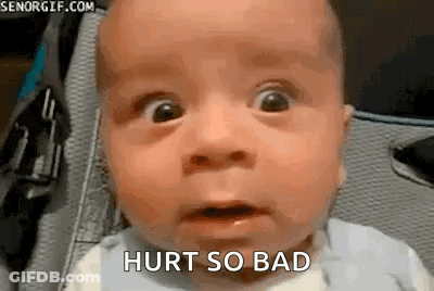 A Baby With A Surprised Look On His Face Is Sitting In A Stroller . GIF