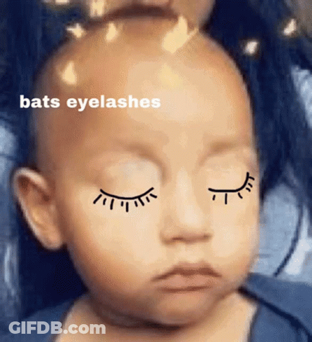 A Baby With Closed Eyes Has Bats Eyelashes On His Face GIF