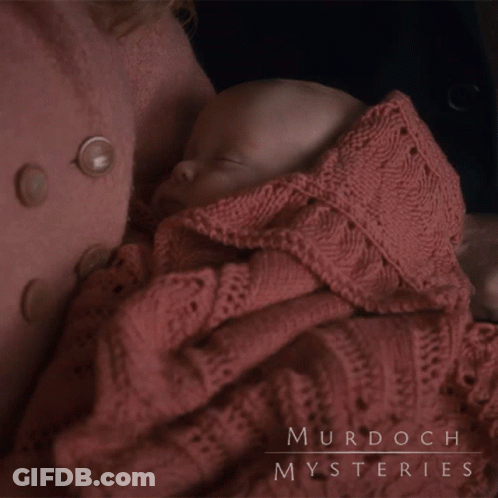 A Baby Wrapped In A Pink Blanket With Murdoch Mysteries Written On The Bottom GIF