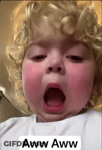 A Baby Yawning With The Words Aww Aww On The Bottom Right GIF