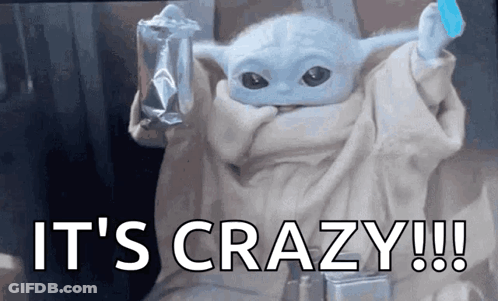 A Baby Yoda From The Mandalorian Is Holding A Bag Of Chips And A Blue Ice Cube . GIF