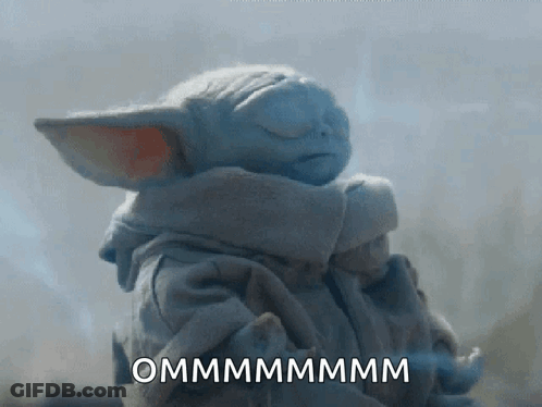 A Baby Yoda From The Mandalorian Is Sleeping With His Eyes Closed And The Words Ommmmmmmm Written On The Bottom . GIF