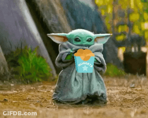 A Baby Yoda Is Holding A Box Of Nuggets In His Hand . GIF