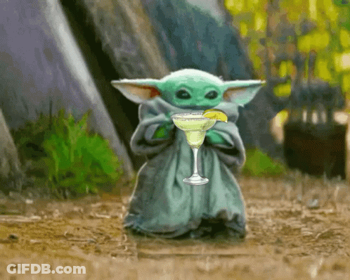 A Baby Yoda Is Holding A Margarita With A Lime Wedge GIF