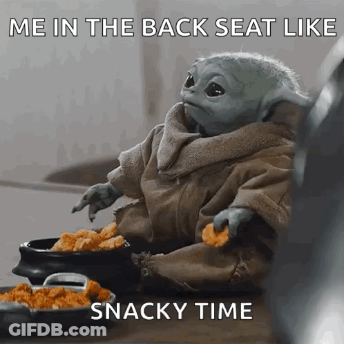 A Baby Yoda Is Sitting On A Table Eating Chicken Nuggets And A Snacky Time Meme . GIF