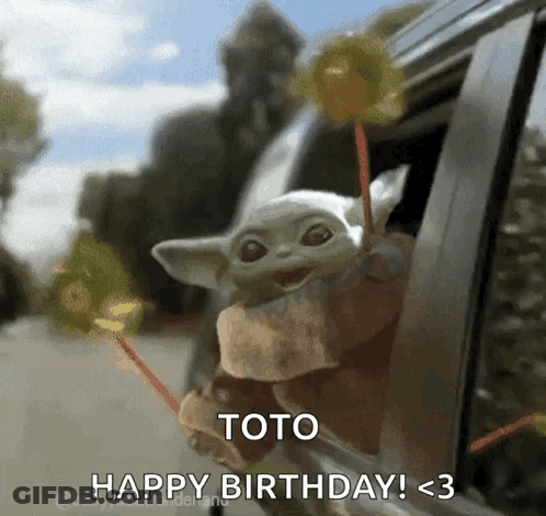 A Baby Yoda Is Sticking Its Head Out Of A Car Window While Holding Lollipops . GIF