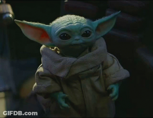 A Baby Yoda Is Wearing A Brown Coat GIF