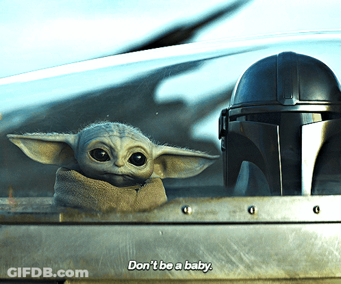 A Baby Yoda Says " Don 'T Be A Baby " Next To A Mandalorian Helmet GIF