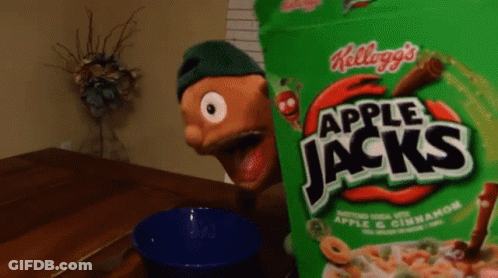 A Bag Of Apple Jacks Cereal Sits On A Table Next To A Blue Bowl GIF