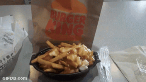 A Bag Of Burger King French Fries Sits On A Table GIF