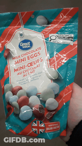 A Bag Of Milk Chocolate Mini Eggs Is Being Held In Someone 'S Hand GIF