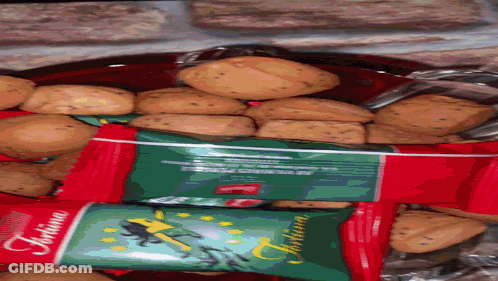 A Bag Of Tortina Cookies Sits Next To A Bowl Of Cookies GIF
