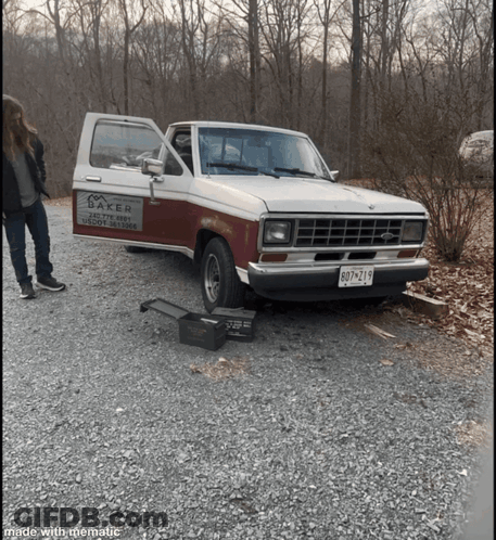 A Baker Truck Is Parked In A Gravel Area GIF