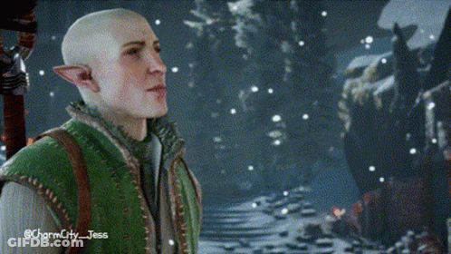 A Bald Elf In A Green Vest Is Standing In A Snowy Forest . GIF