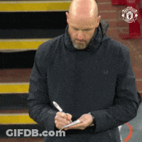 A Bald Man In A Black Jacket Is Writing On A Piece Of Paper With A Pen GIF