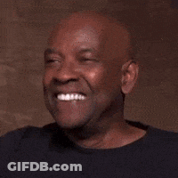 A Bald Man In A Black Shirt Is Laughing And Smiling . GIF