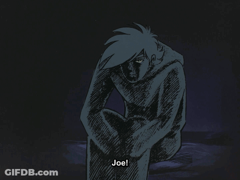 A Bald Man In A Black Suit Is Standing In Front Of A Door GIF
