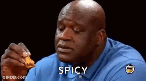 A Bald Man In A Blue Shirt Is Eating Chicken Nuggets And Says Spicy . GIF
