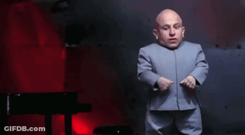 A Bald Man In A Blue Suit Is Dancing In Front Of A Piano . GIF