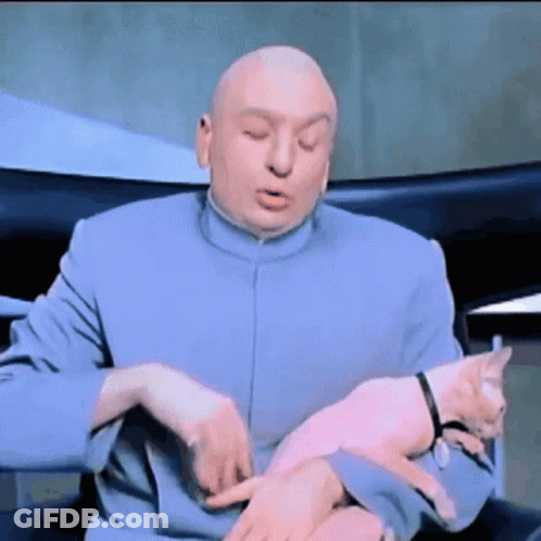 A Bald Man In A Blue Suit Is Holding A Small Pink Cat GIF