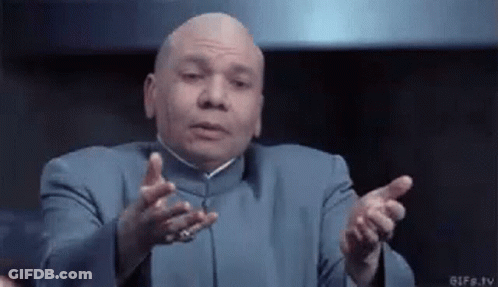 A Bald Man In A Blue Suit Is Making A Funny Face With His Hands Outstretched GIF