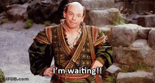 A Bald Man In A Costume Is Standing On A Set Of Stairs . GIF