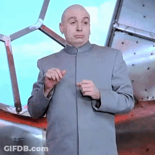 A Bald Man In A Gray Suit Is Standing In Front Of A Window . GIF