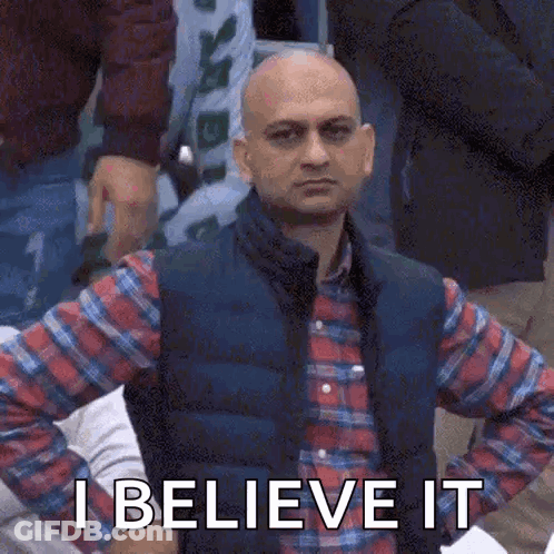 A Bald Man In A Plaid Shirt And Vest Is Holding His Hands On His Hips And Says `` I Believe It '' GIF