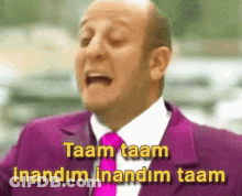 A Bald Man In A Purple Suit And Tie Says Taam Taam Inandim Inandim Taam GIF
