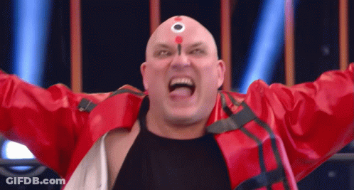 A Bald Man In A Red Jacket Has A Circle On His Forehead GIF