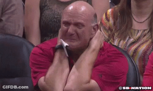 A Bald Man In A Red Shirt Is Crying In A Stadium . GIF