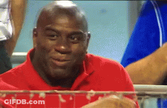 A Bald Man In A Red Shirt Is Looking At Something GIF