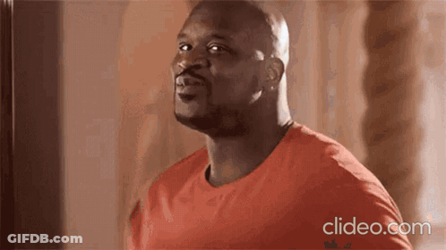 A Bald Man In A Red Shirt Is Looking Up At The Sky . GIF