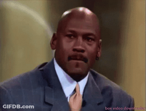 A Bald Man In A Suit And Tie Is Being Touched By A Hand GIF