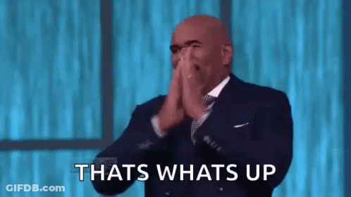 A Bald Man In A Suit And Tie Is Clapping His Hands And Saying `` That 'S What 'S Up '' . GIF