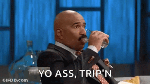A Bald Man In A Suit And Tie Is Drinking Water From A Glass . GIF
